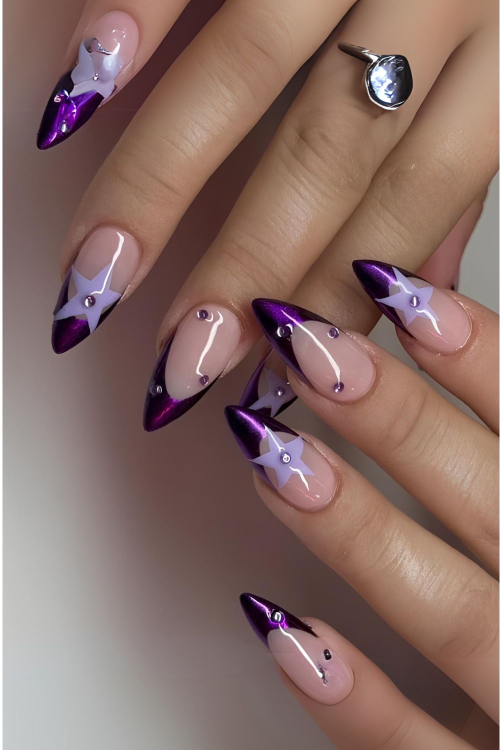 Purple chrome French tip nails with light purple stars and rhinestones