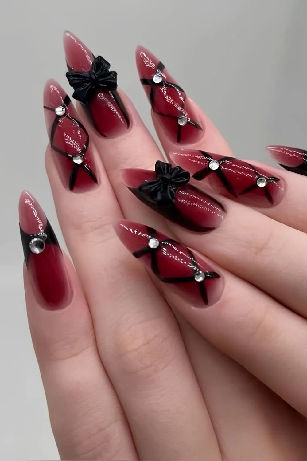 Red and black nails with 3d Bows and rhinestone accents