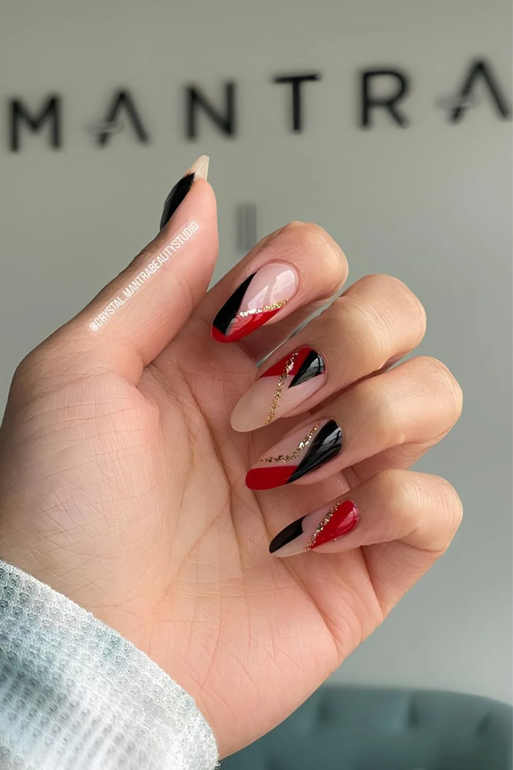 Red and black nails with gold glitter touch