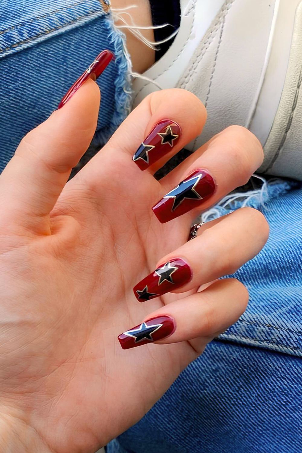 Red nails with black and gold star accents