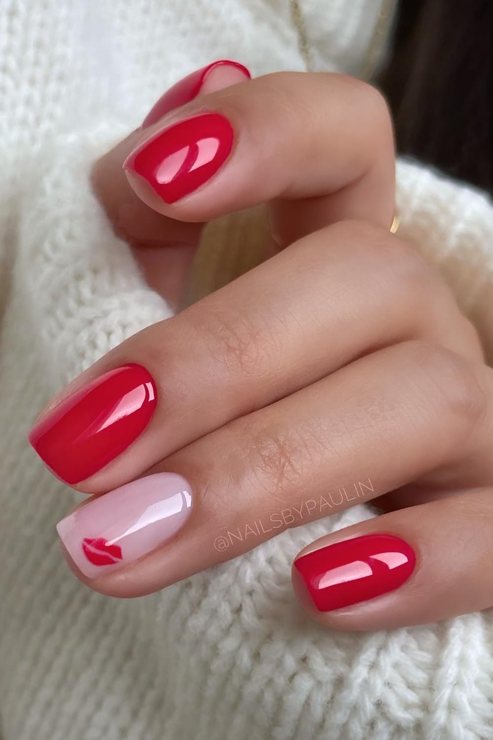 Red nails with minimalist kissy lip art