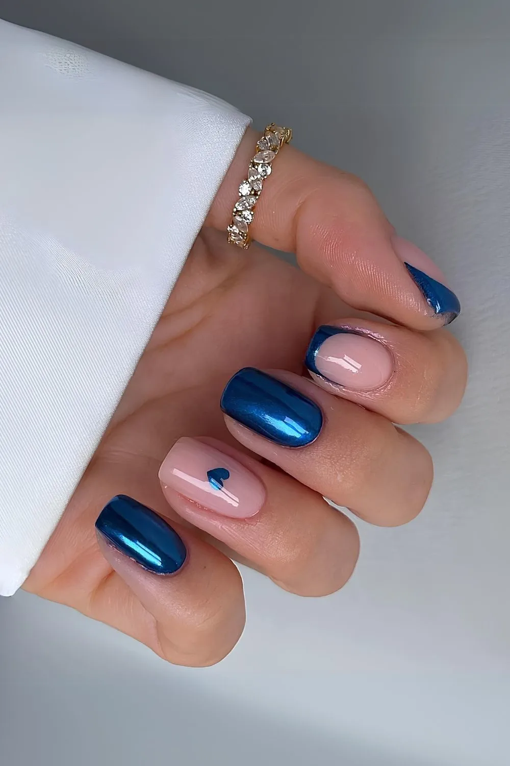 Sapphire blue chrome nails with heart accent