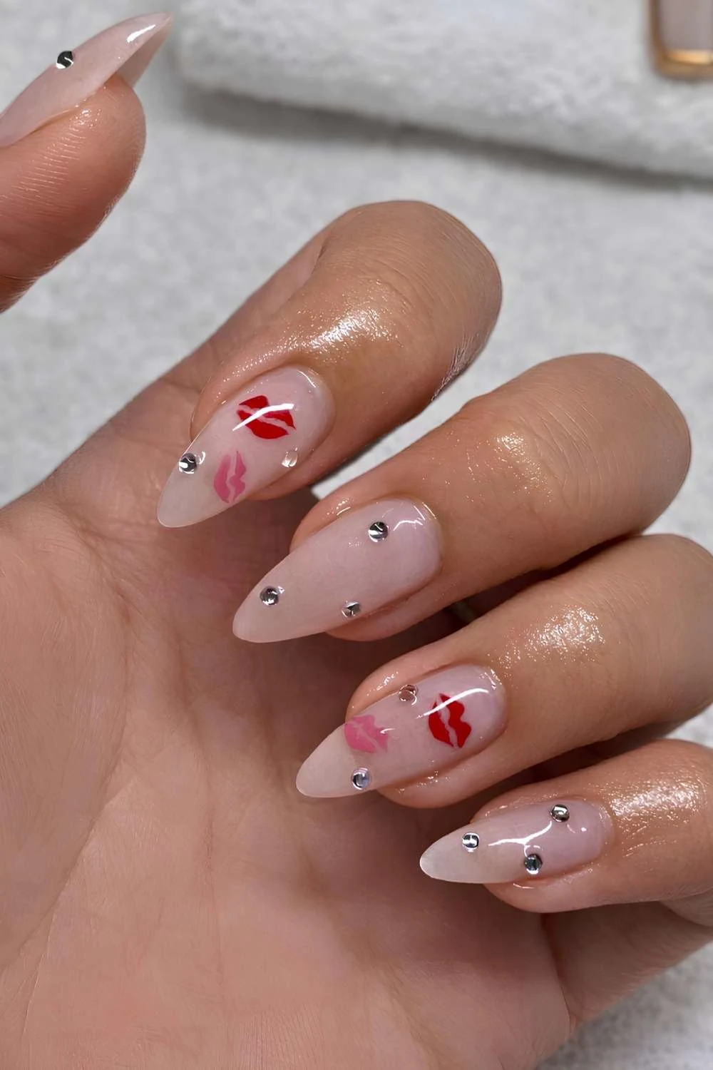 Sheer milky nails with gems and kissy art