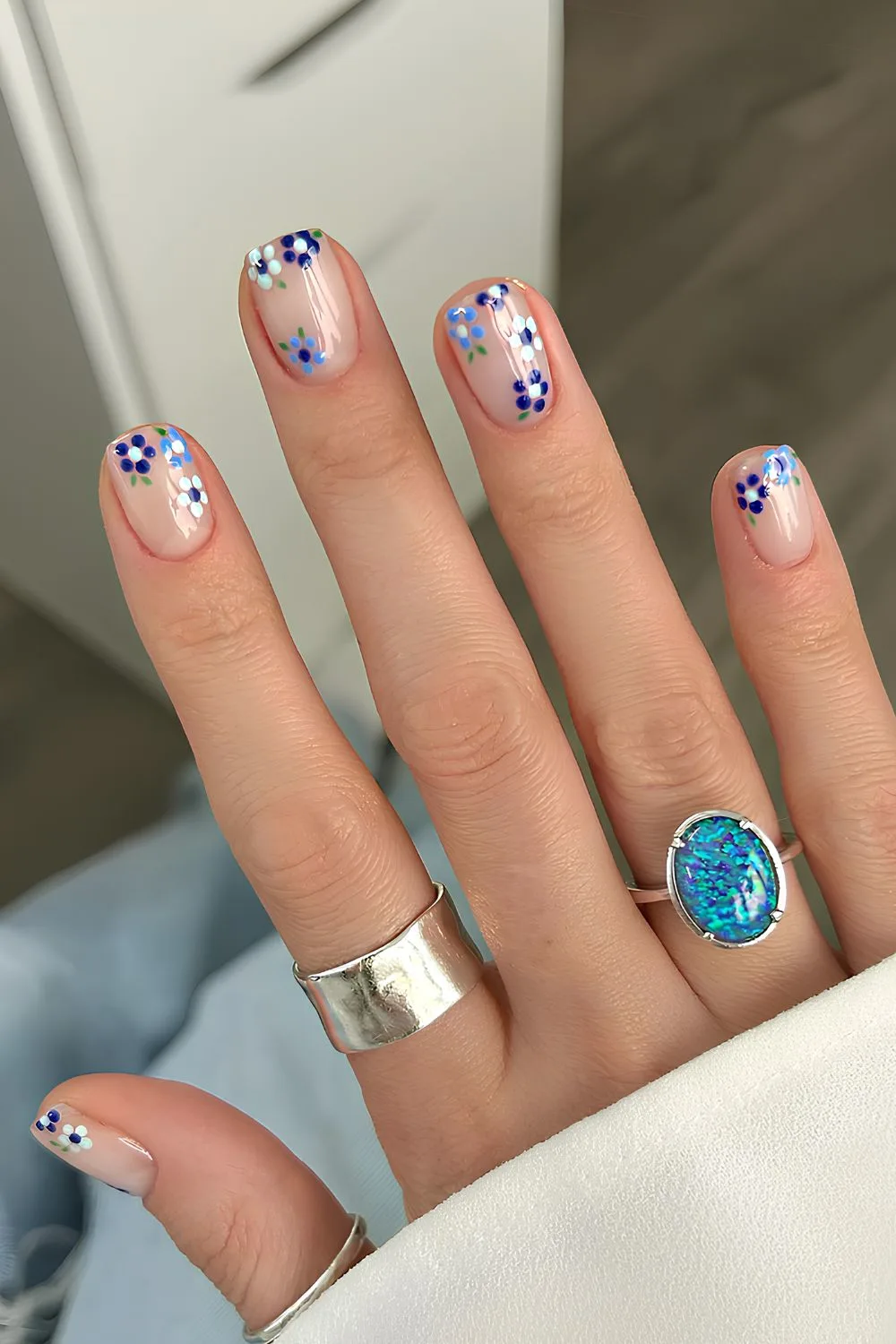 Sheer white nails with accent blue flowers