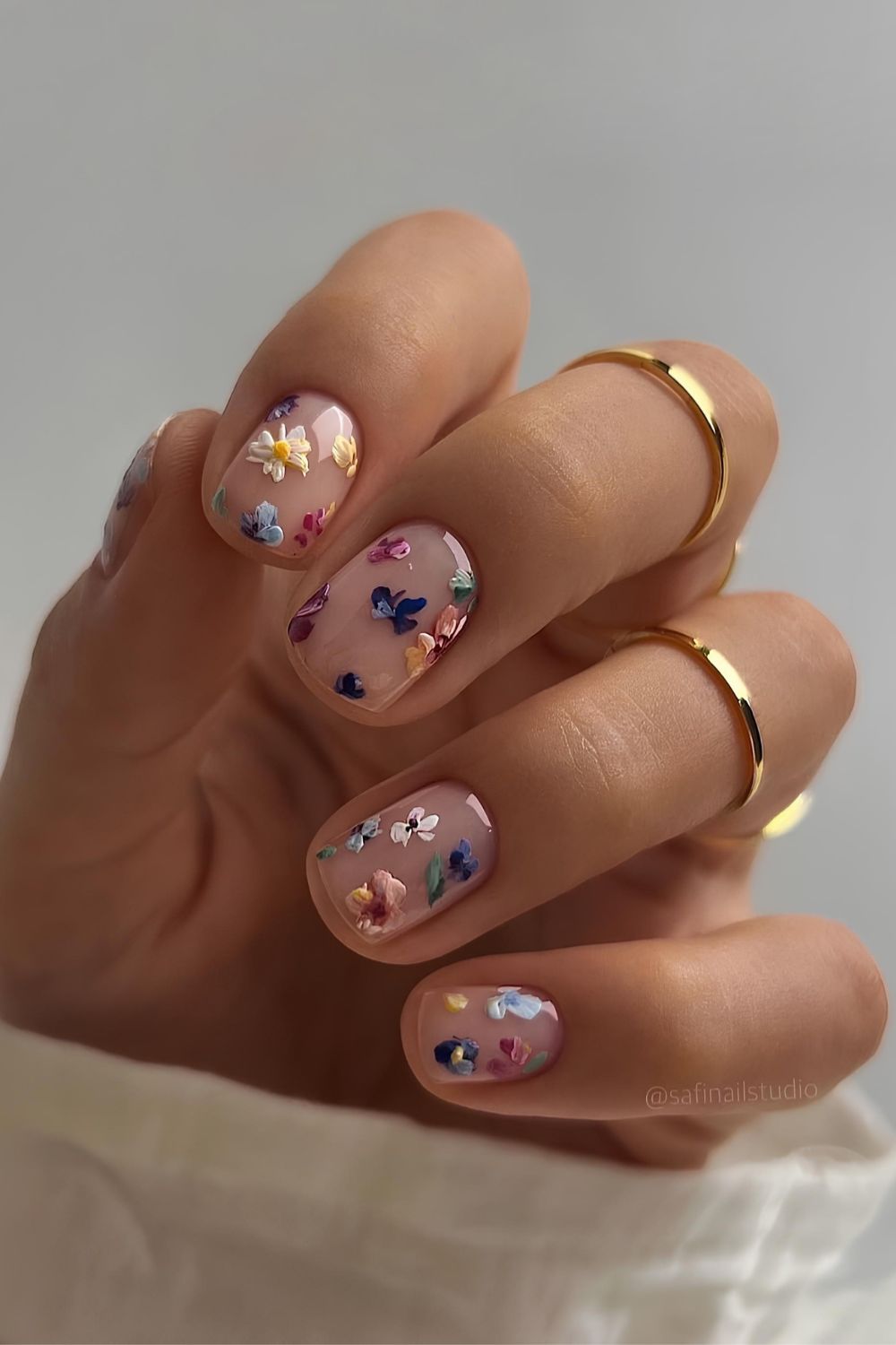 Sheer white nails with colorful flower art