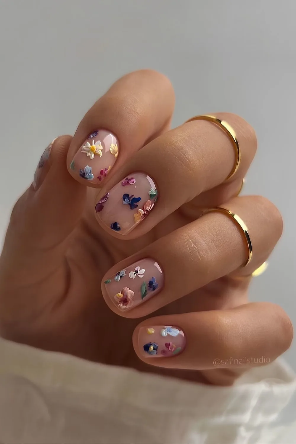 Sheer white nails with colorful flower art