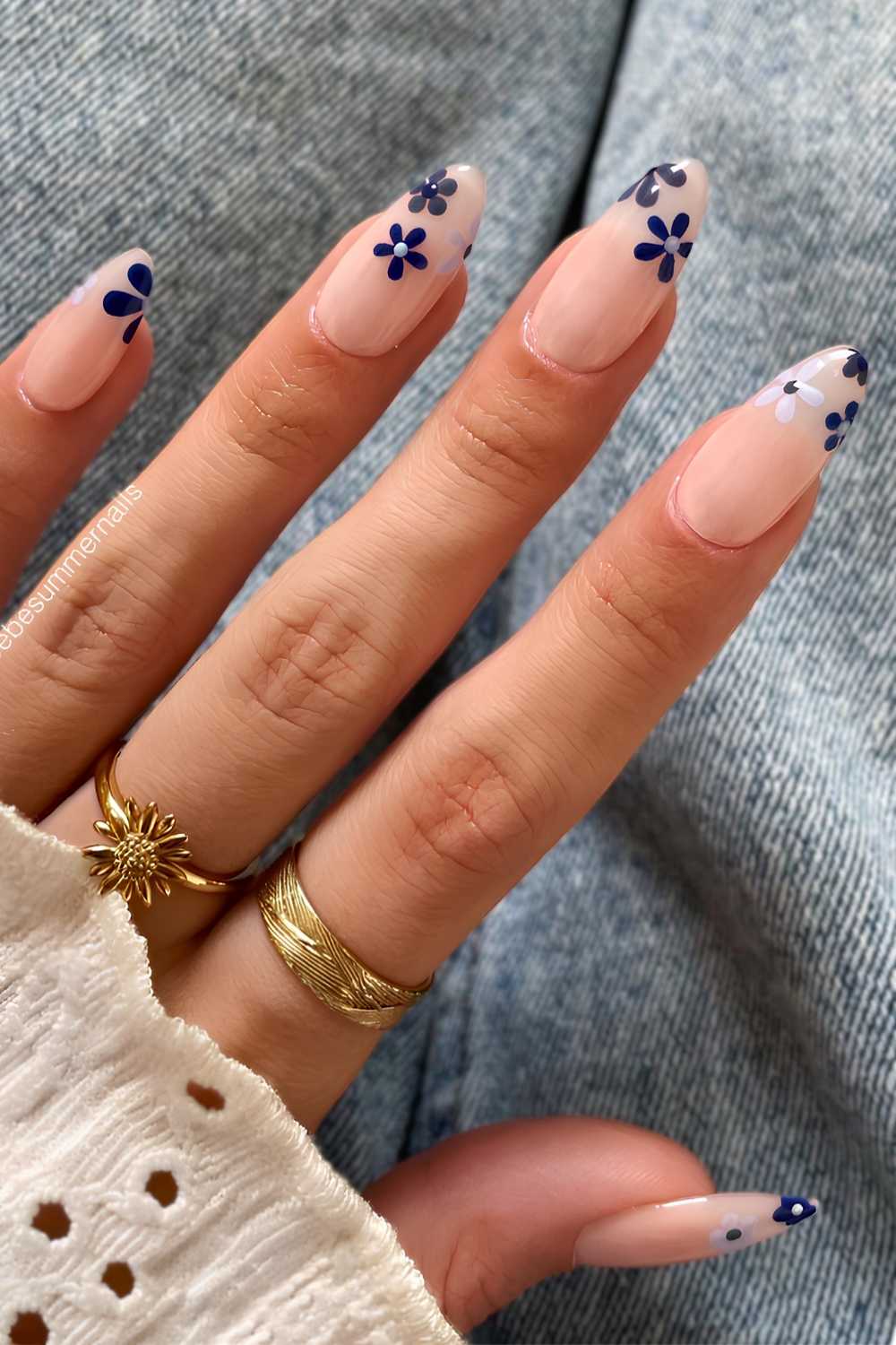 Sheer white nails with navy flowers