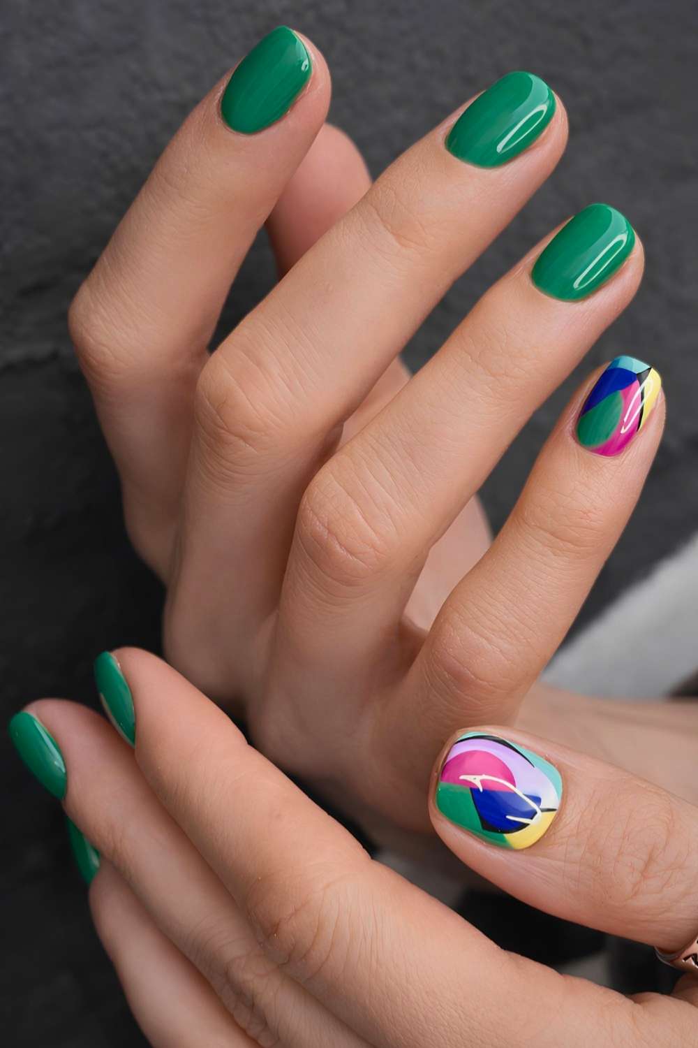Short green nails with colorful accent art