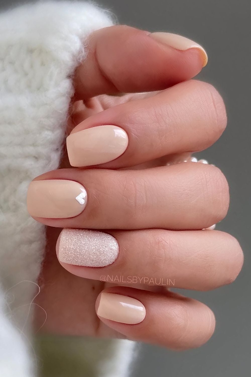 Short neutral nails with hearts and glitter