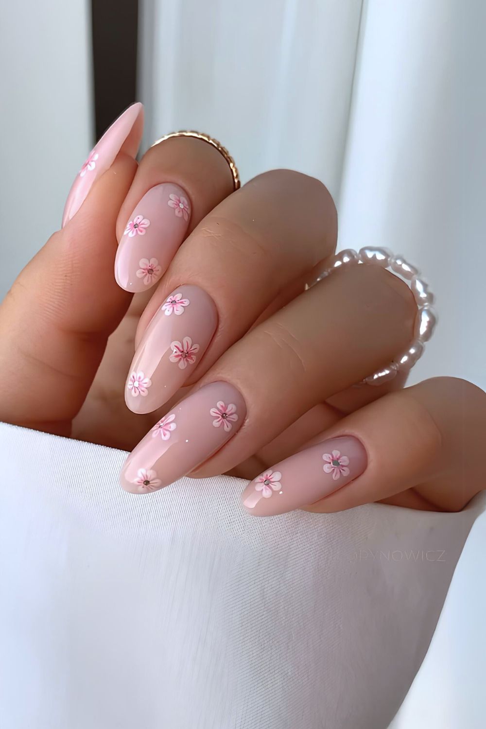 Soft pink nails with tiny flowers