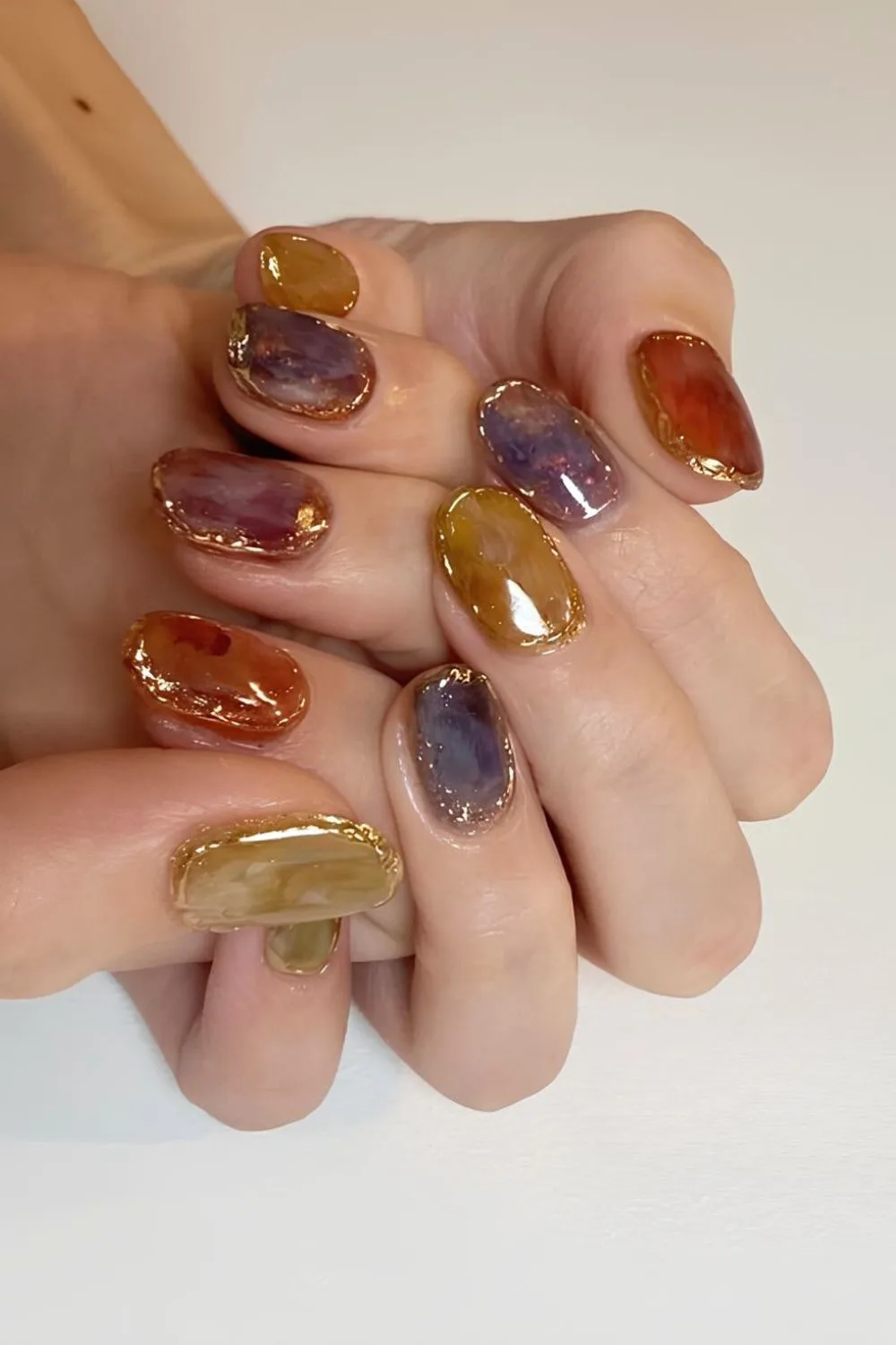 Stone inspired marble nails with gold chrome rings