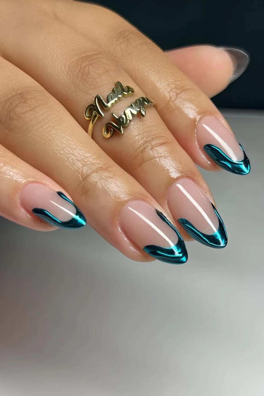 Turquoise chrome French nails with abstract swirl tips