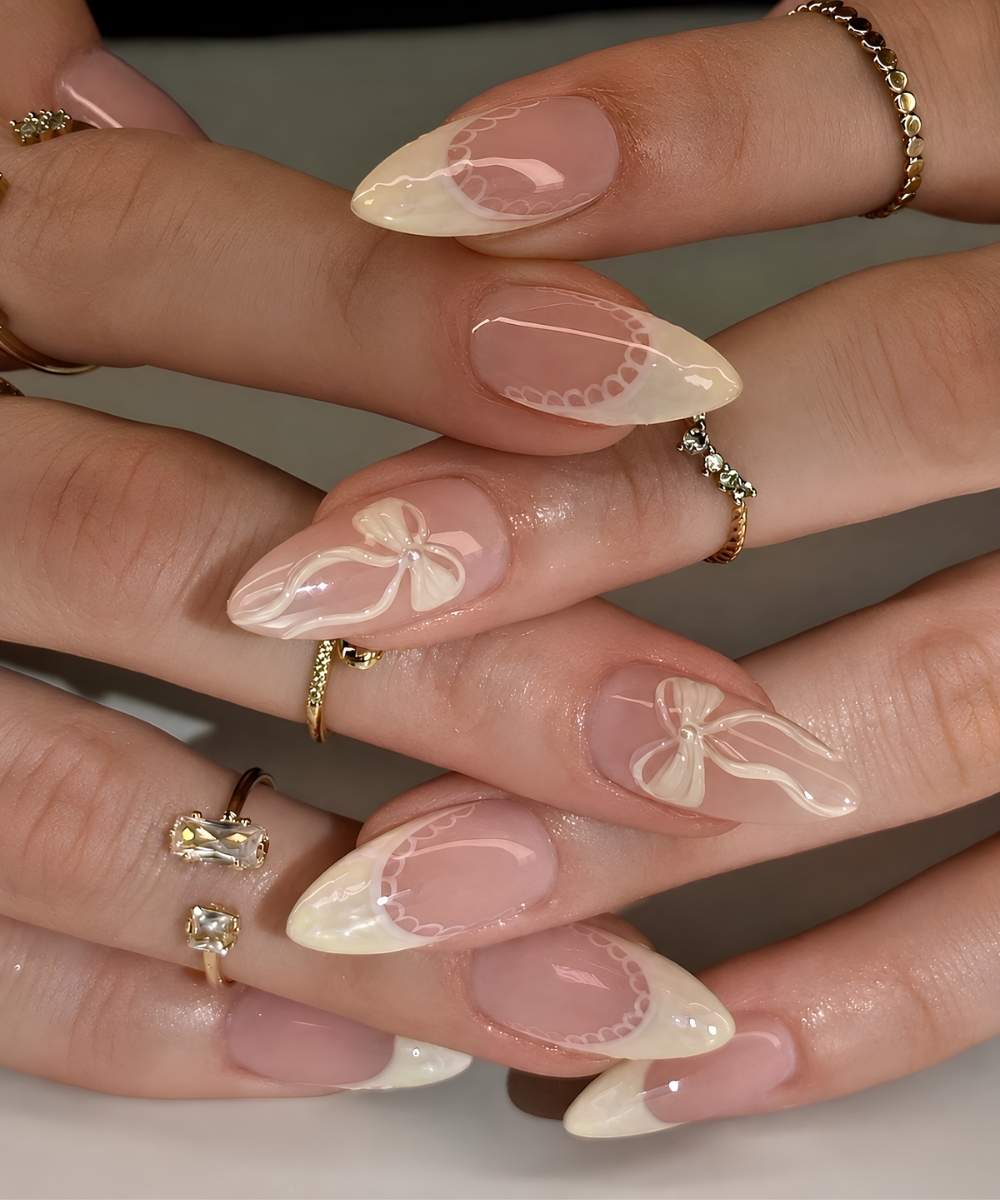 Vanilla French nails with lace and bow art