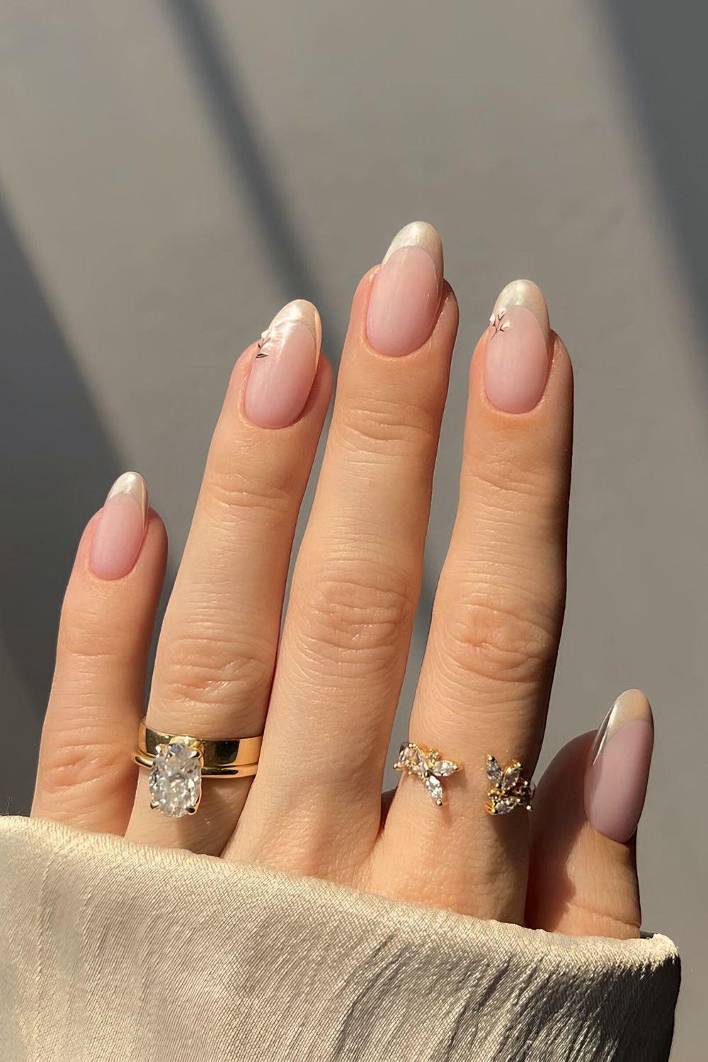 Vanilla chrome French tip nails with tiny floral accents