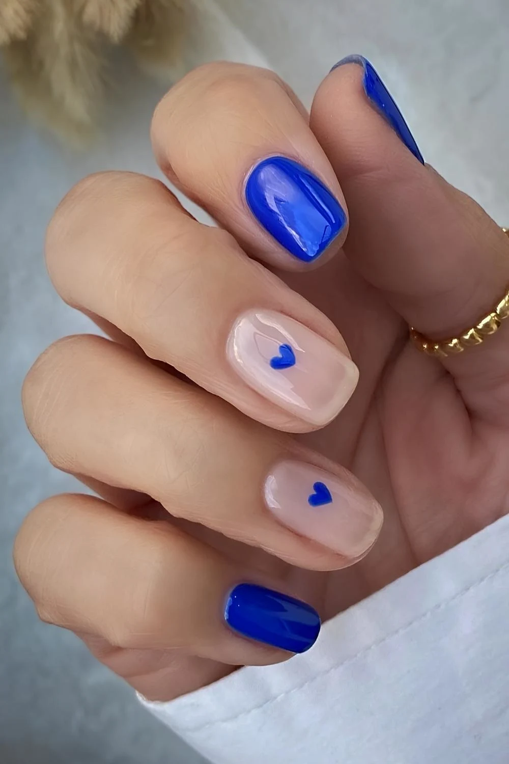 Vibrant blue nails with hearts