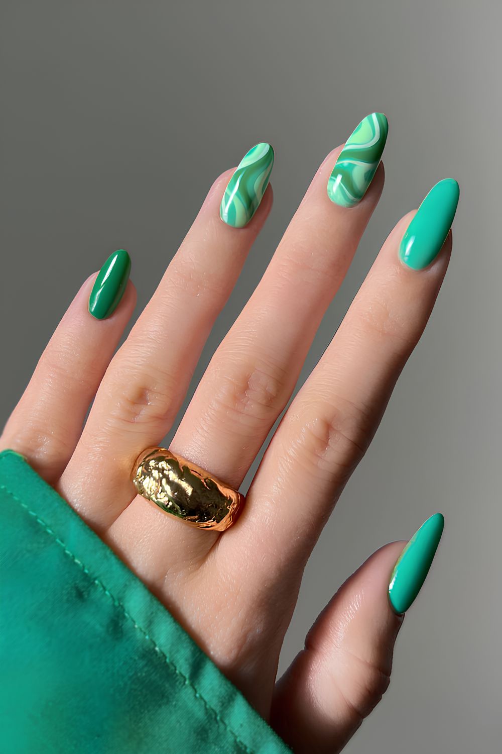 Vibrant green nails with marble accents