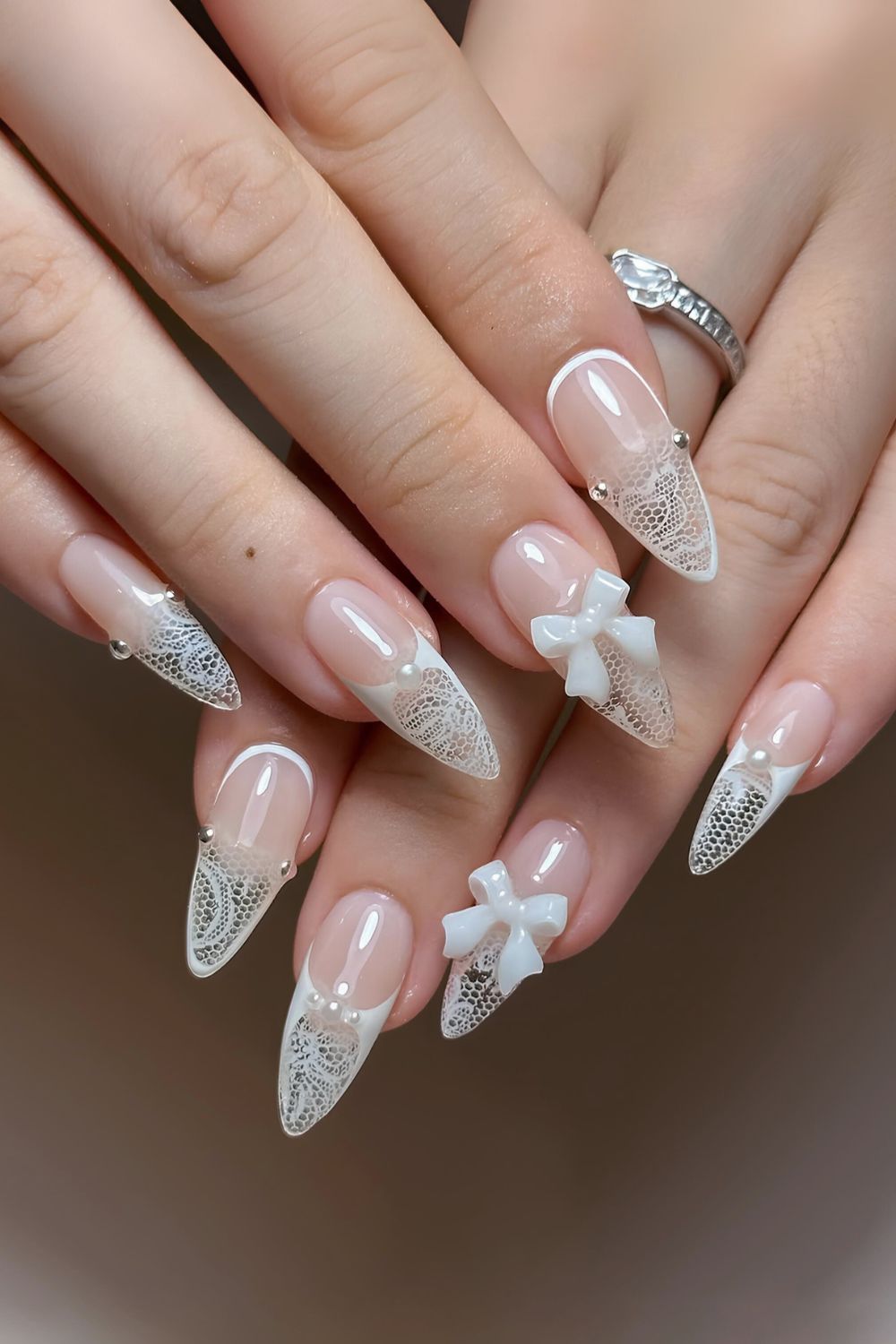 White lace-effect French nails with bows