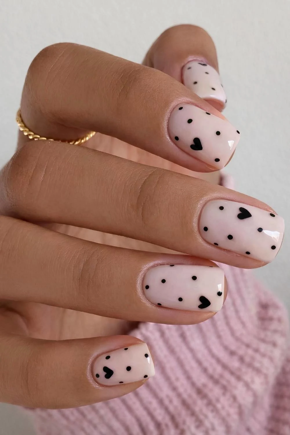 White nails with black dots and hearts