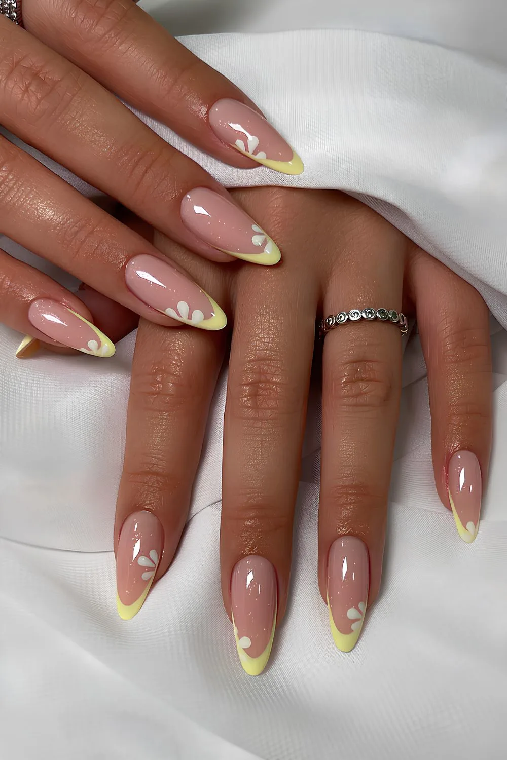 Yellow French tip nails with daisies