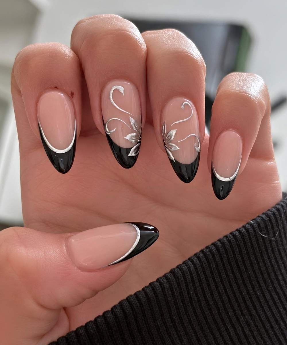 Black French nails with silver outlines and flowers