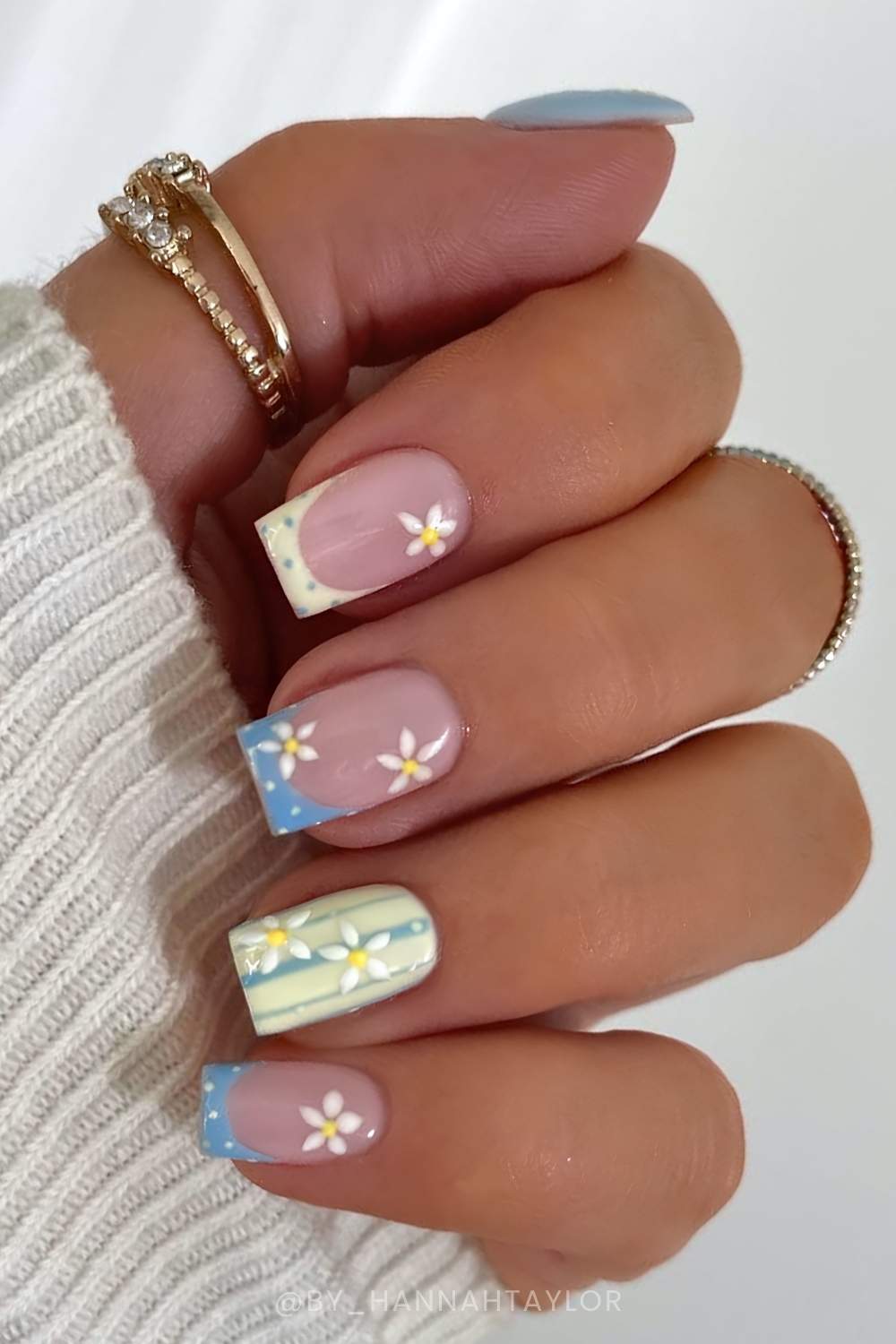 Blue and yellow nails with stripes and flowers