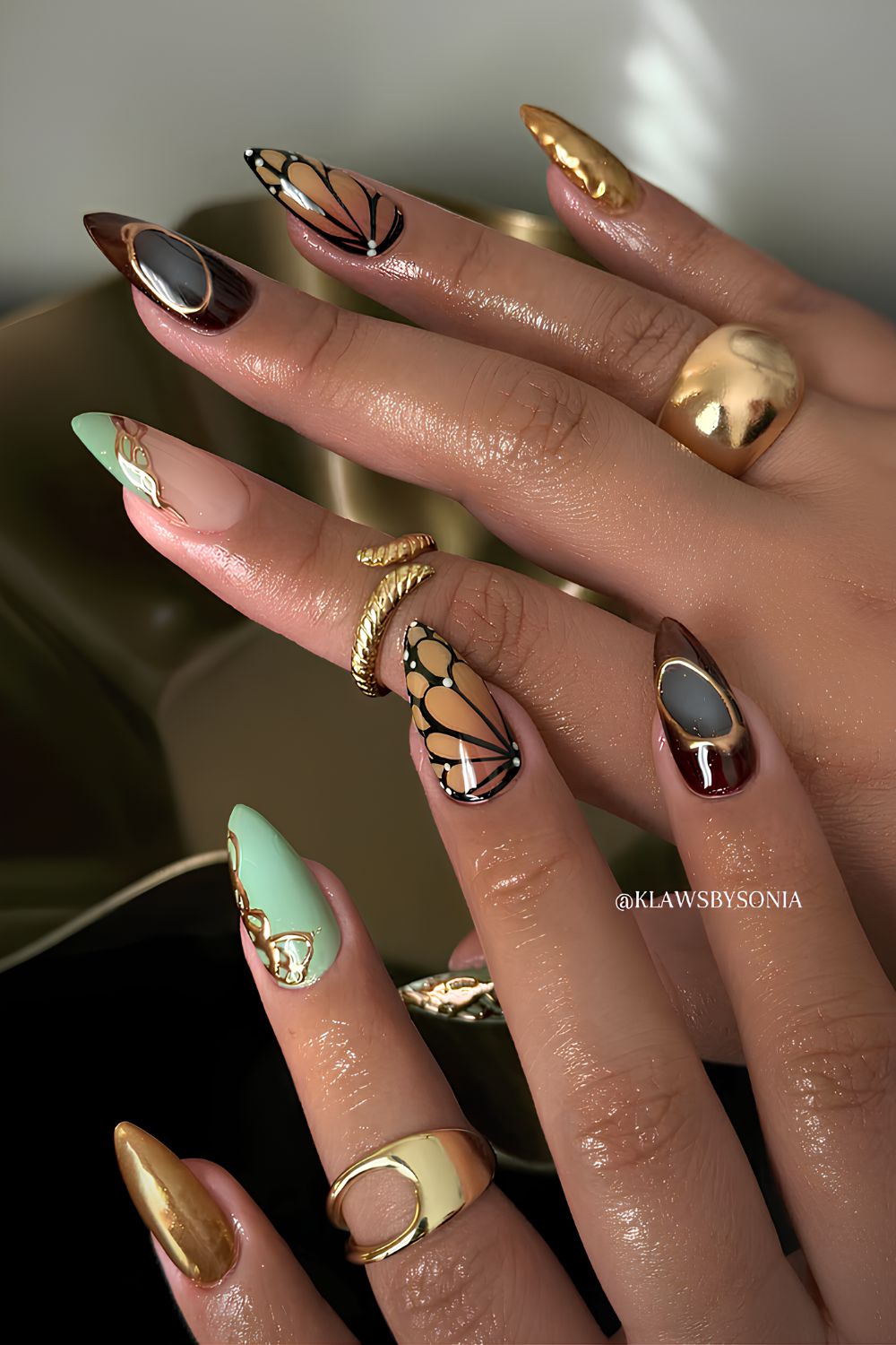 Brown and blue mani with butterfly art