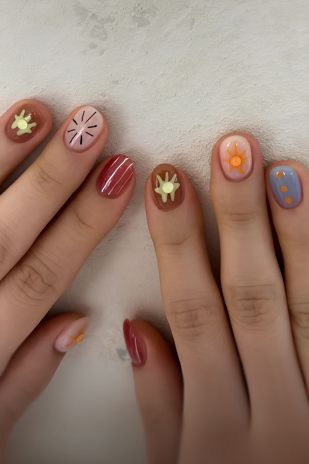 Colorful mani with tiny doodle on each nail