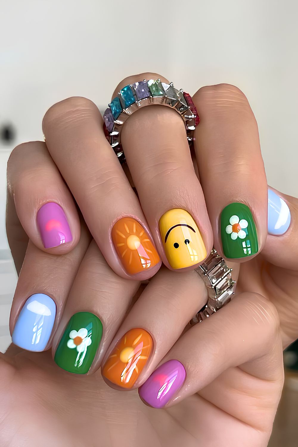 Colorful mix and match nails with smiley faces