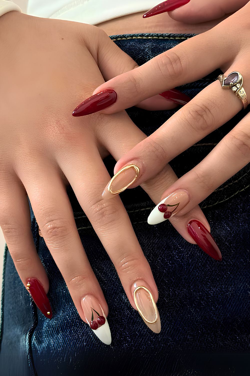 Dark red mani with cherries and gold chrome