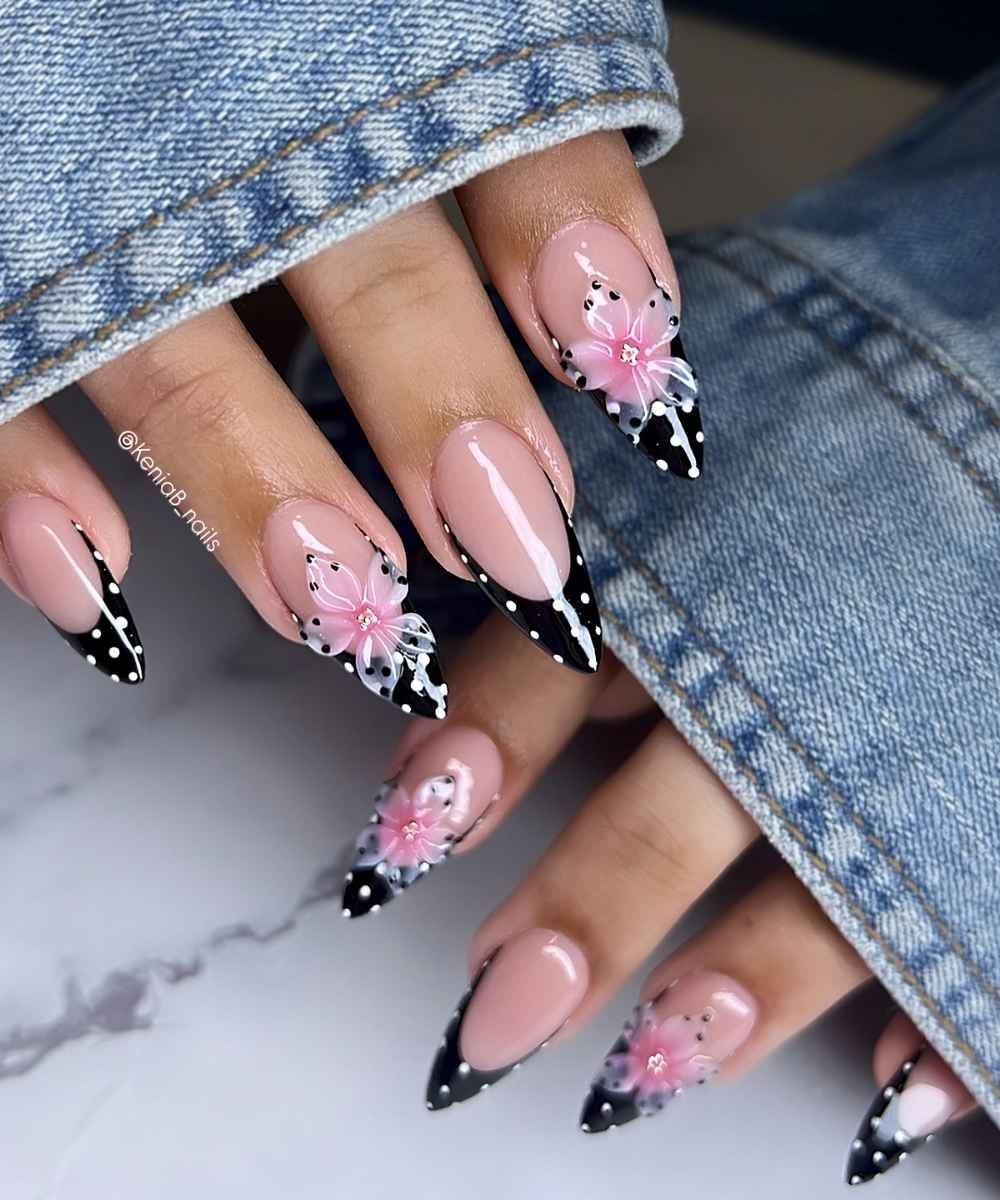 Dotted black French nails with pink flowers