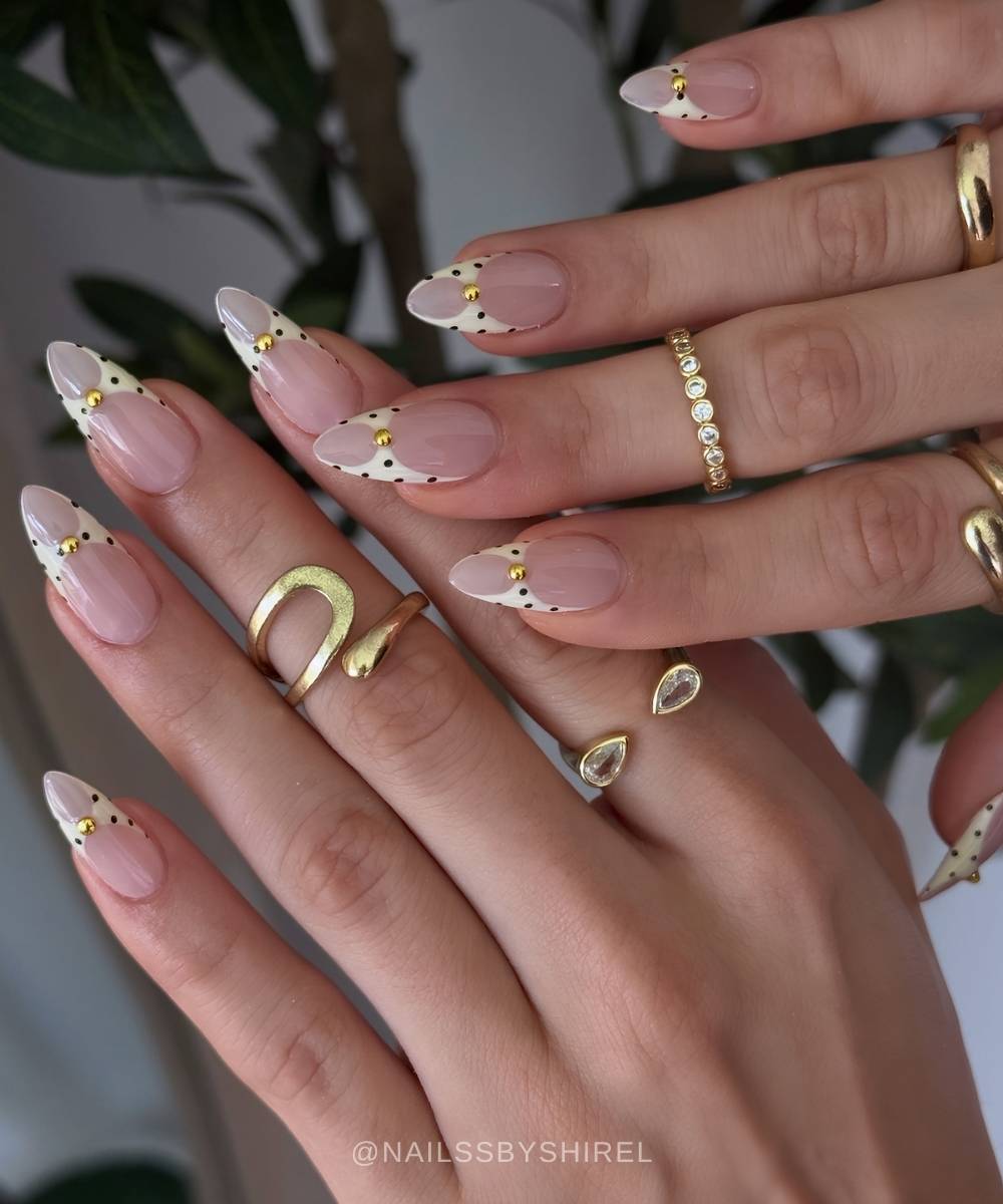 Dotted vanilla French nails with aesthetic cutouts