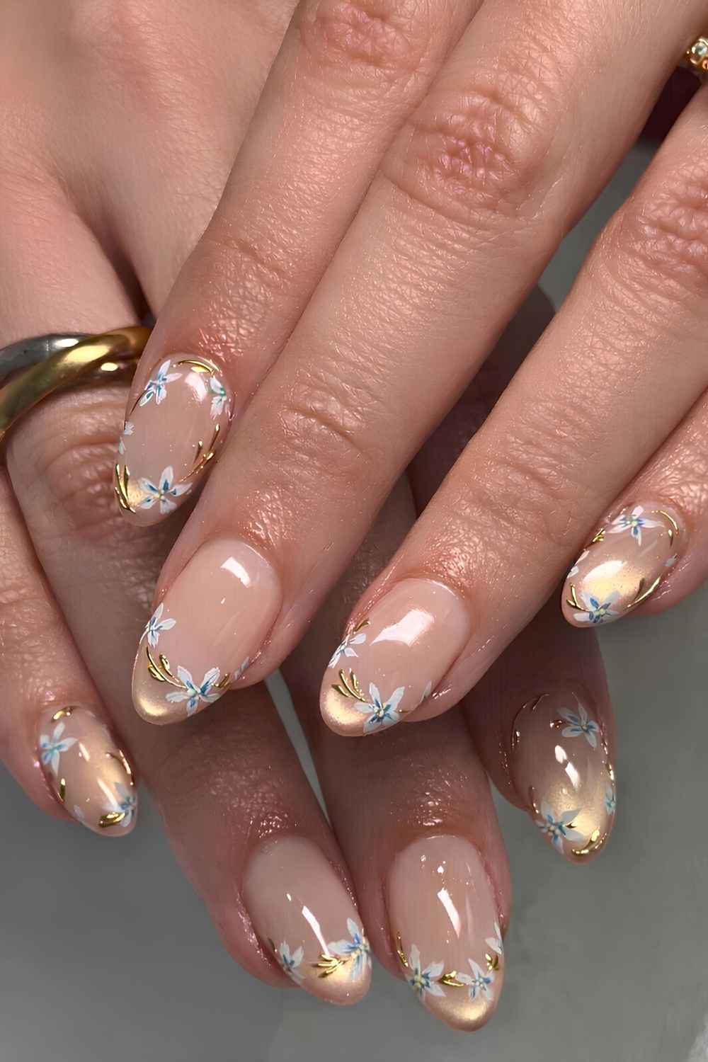 Gold cat eye nails with blue flower art