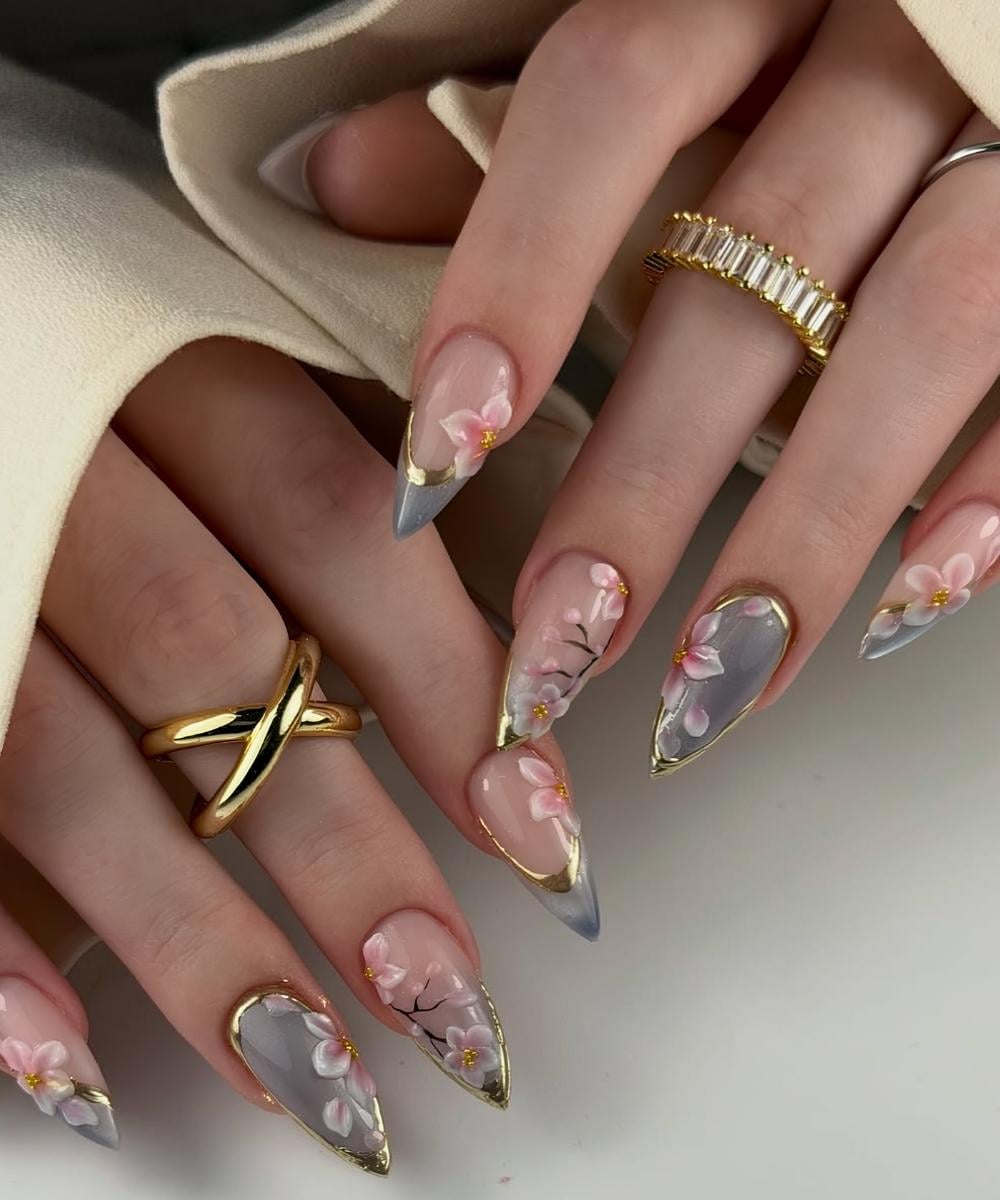 Gray cat eye nails with gold and cherry blossom accents