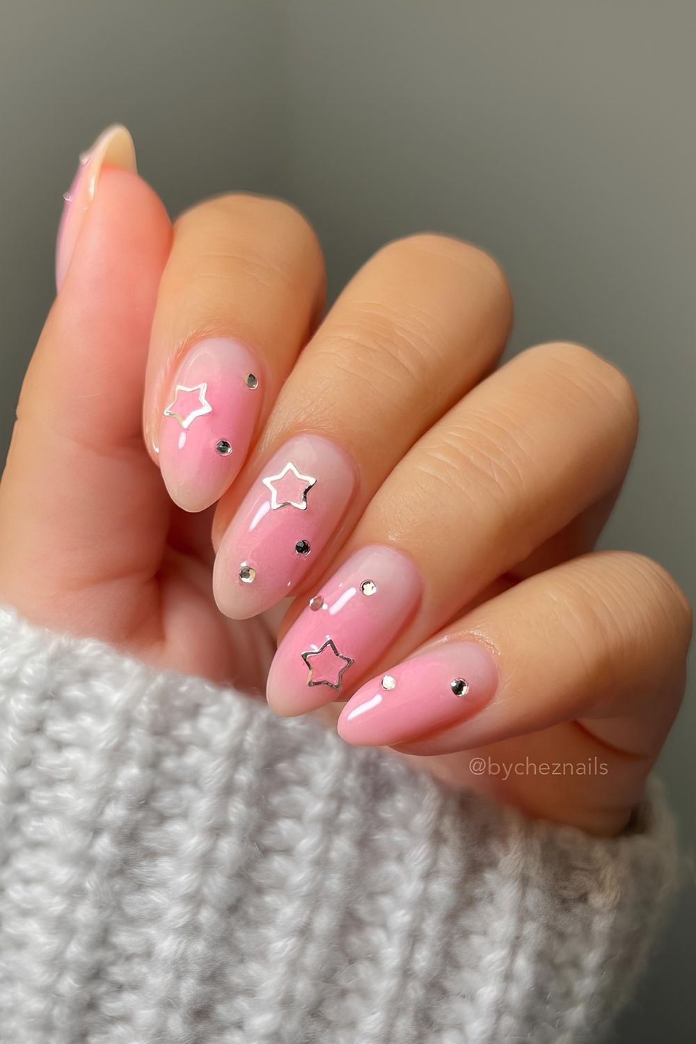 Milky pink nails with silver stars and rhinestones