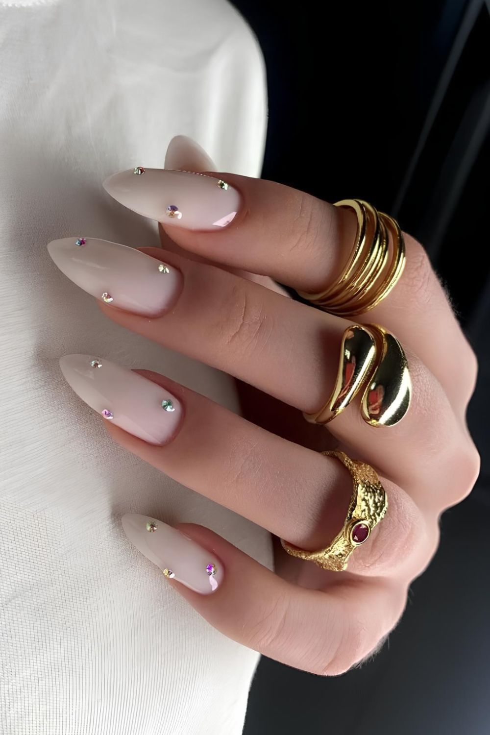 Milky white mani with gem accents