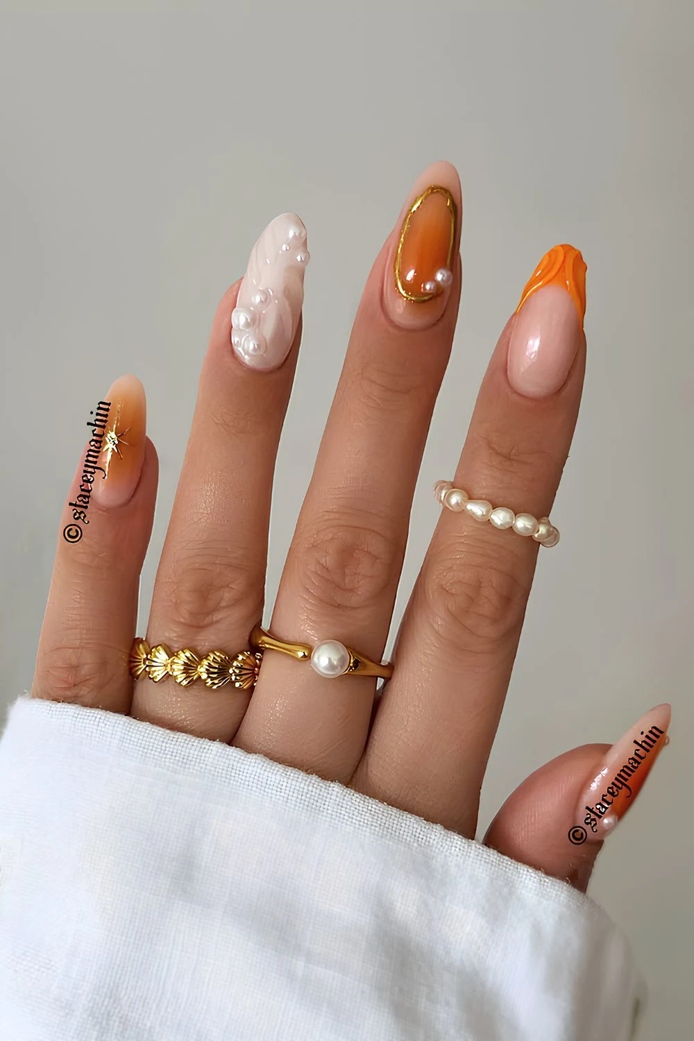 Orange mix and match nails with pearls