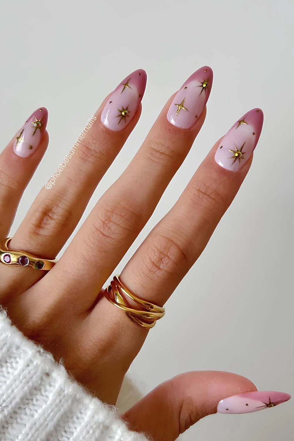 Pastel pink French tip nails with gold star accents