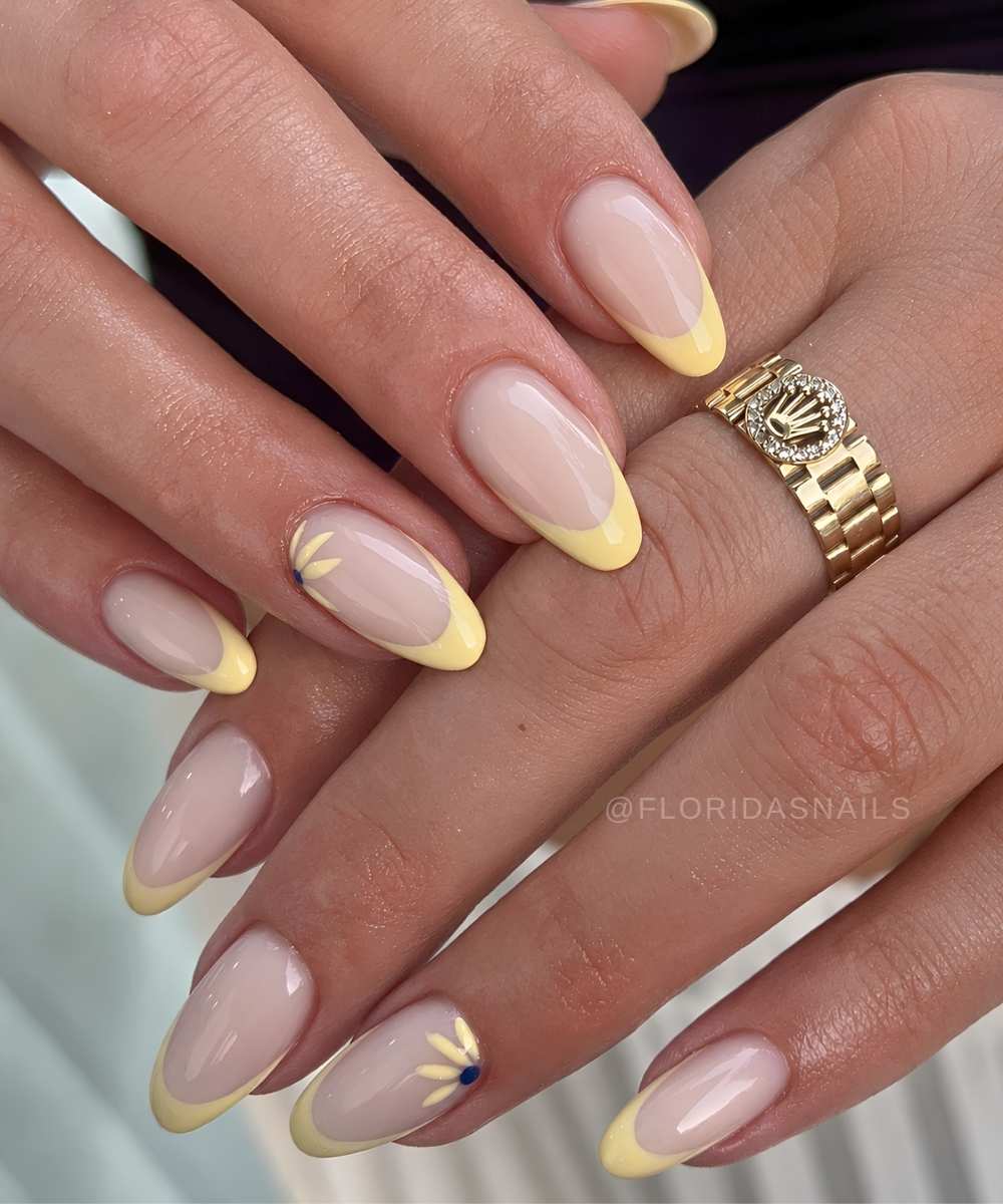 Pastel yellow French nails with sunflowers