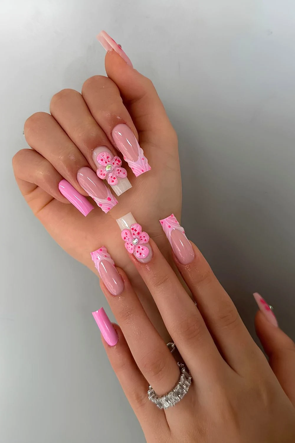 Pink French tip nails with 3D accents