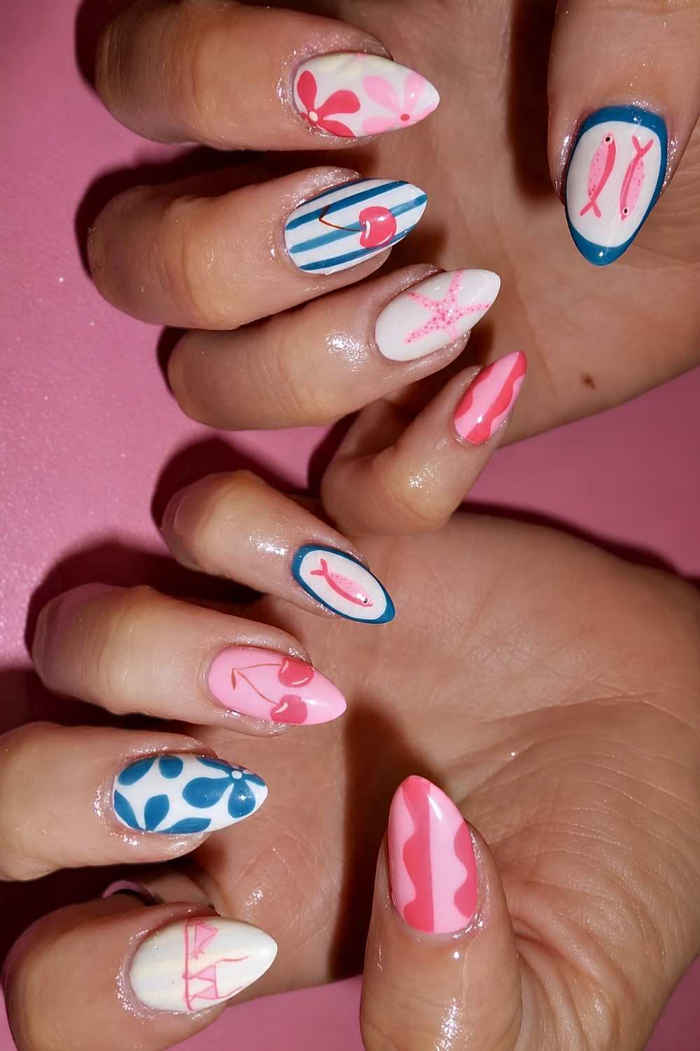 Pink and blue nails with cherries and beach themed art