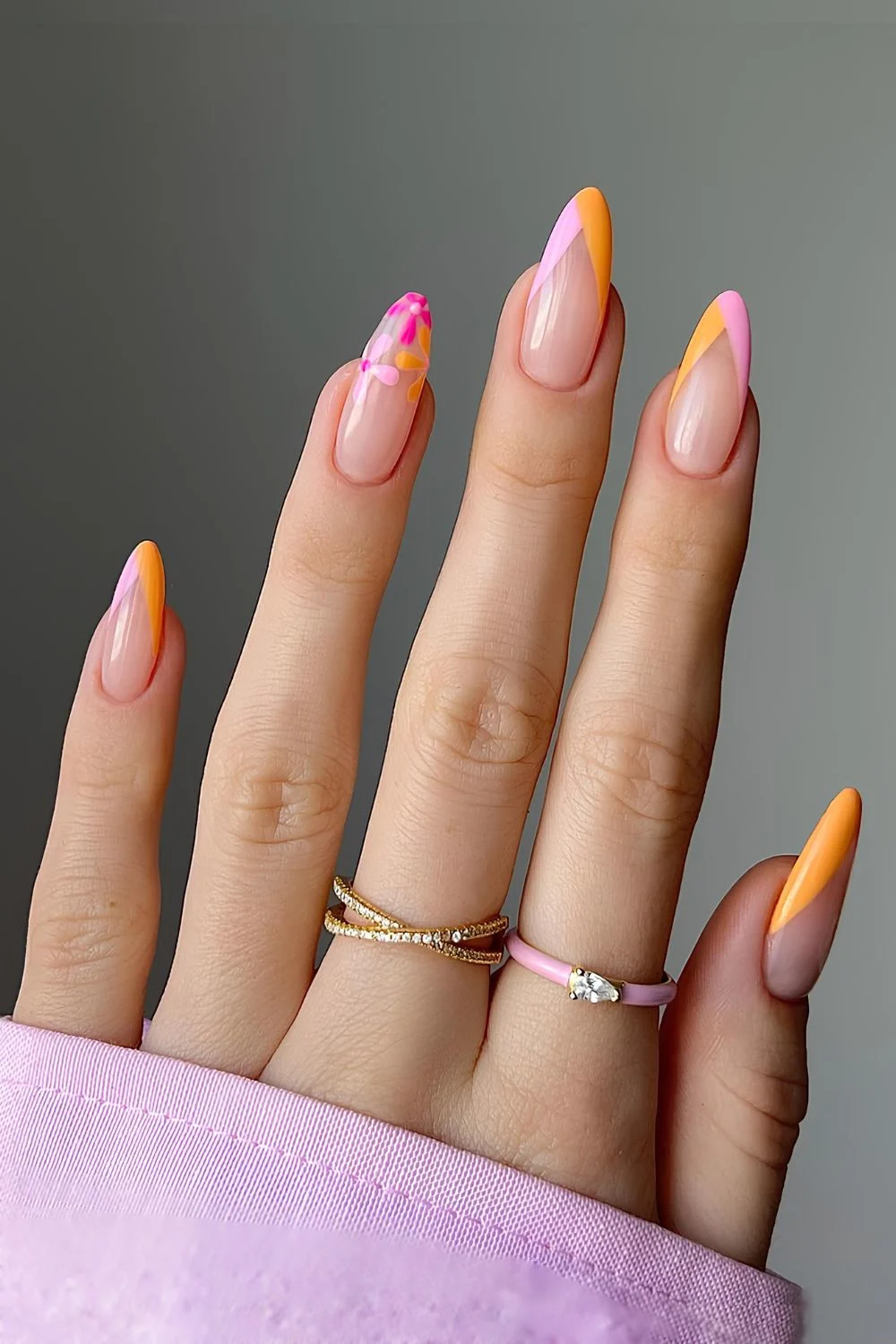 Pink and orange pointed french tips with floral accents