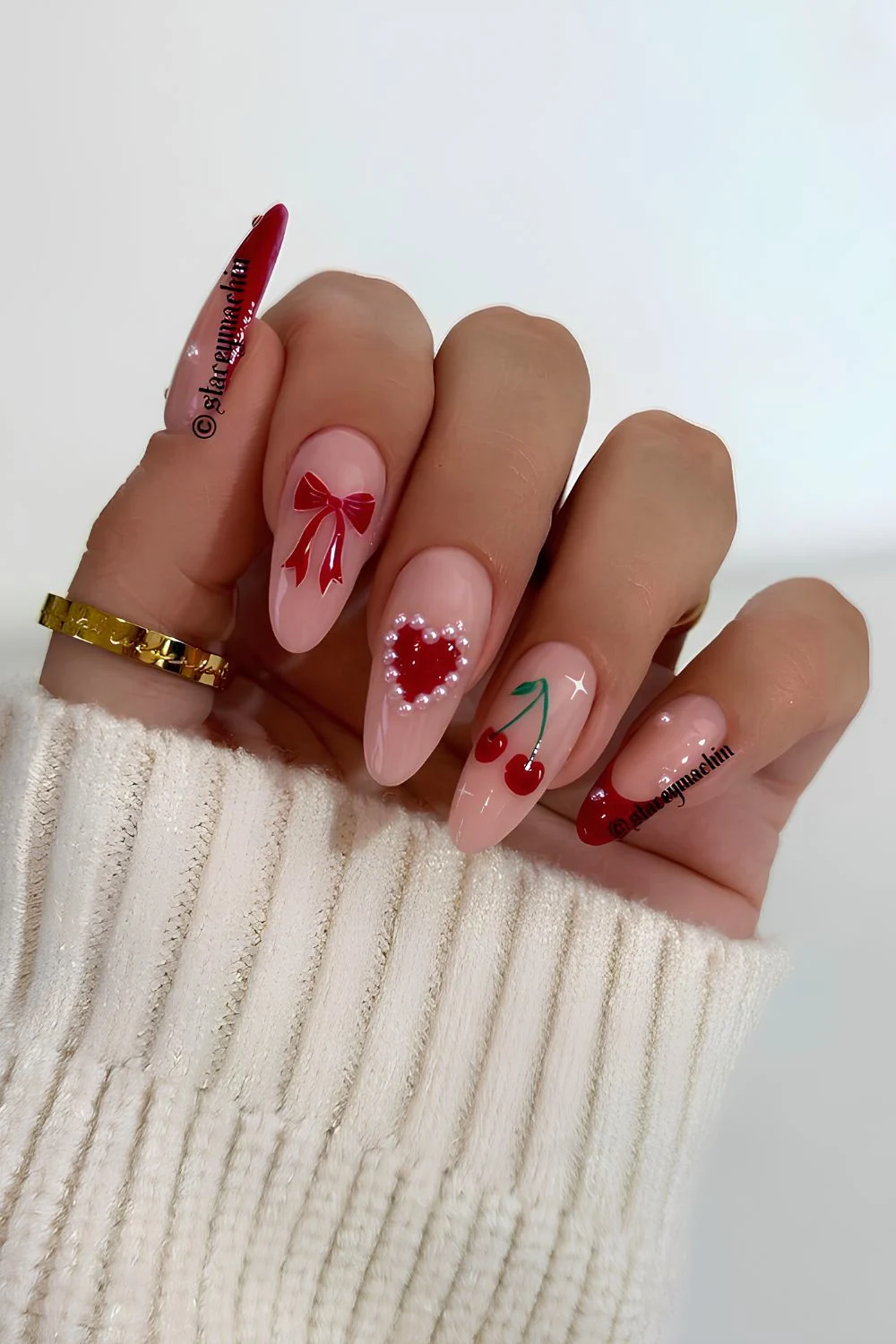 Pink nails with red cherry and heart accents