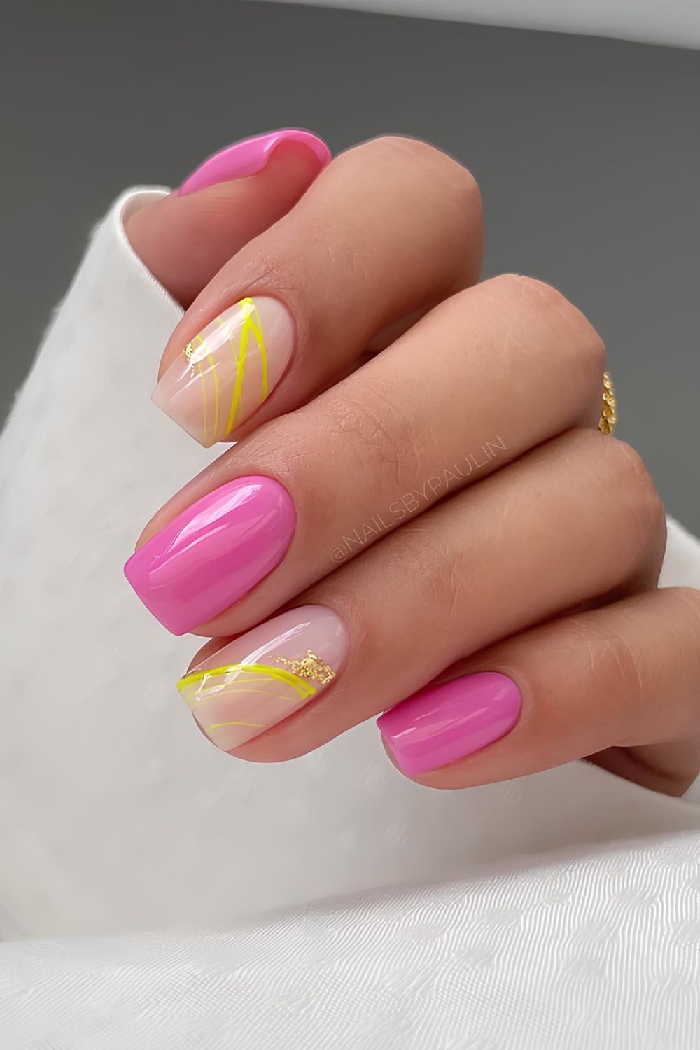 Pink nails with yellow line accents