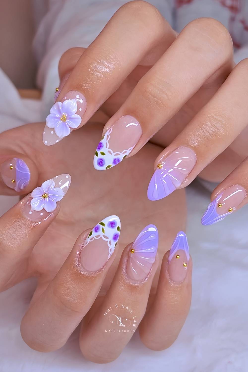 Purple and white nails with flowers and dots