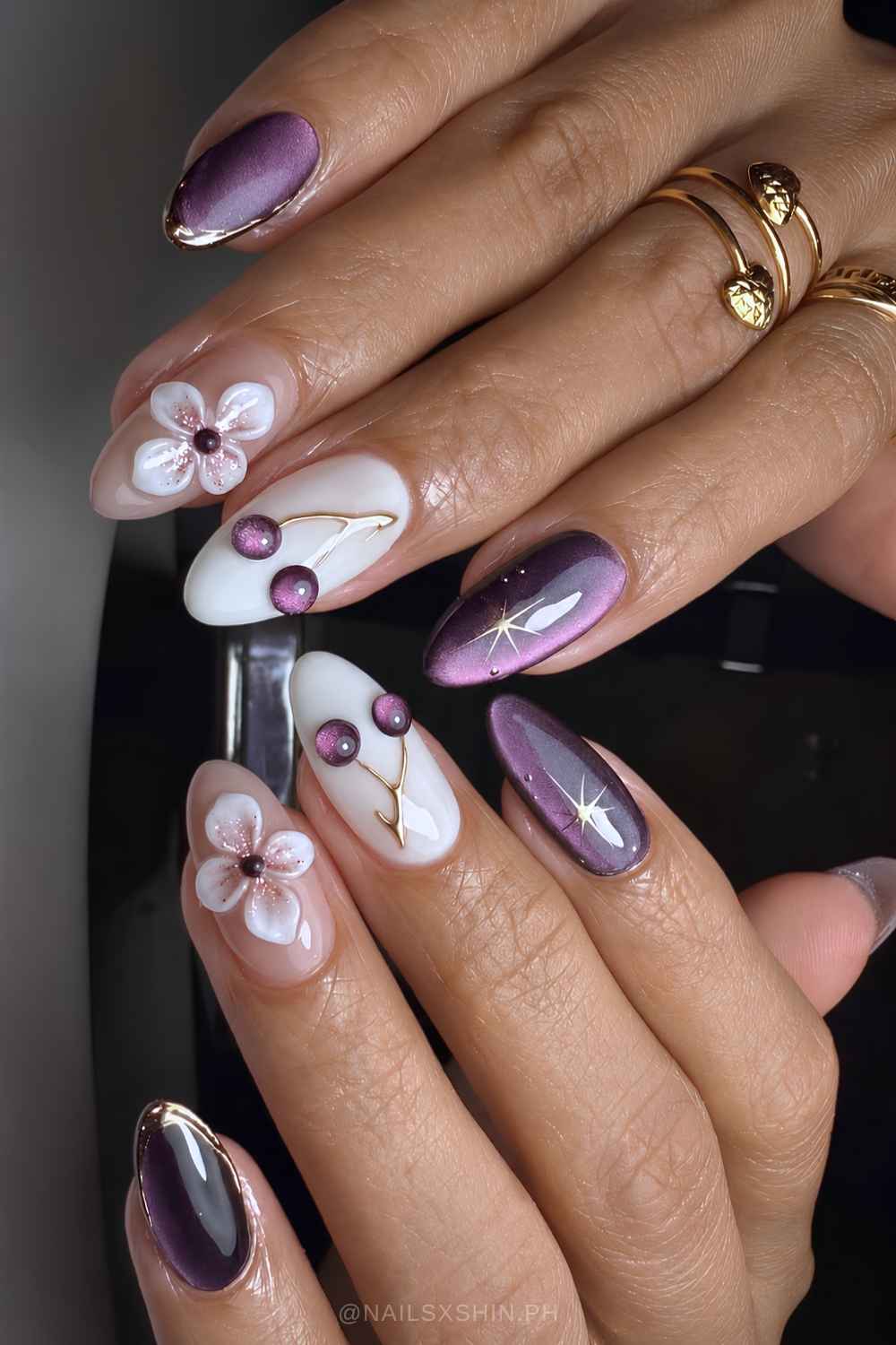 Purple cat eye nails with 3d flowers and cherries