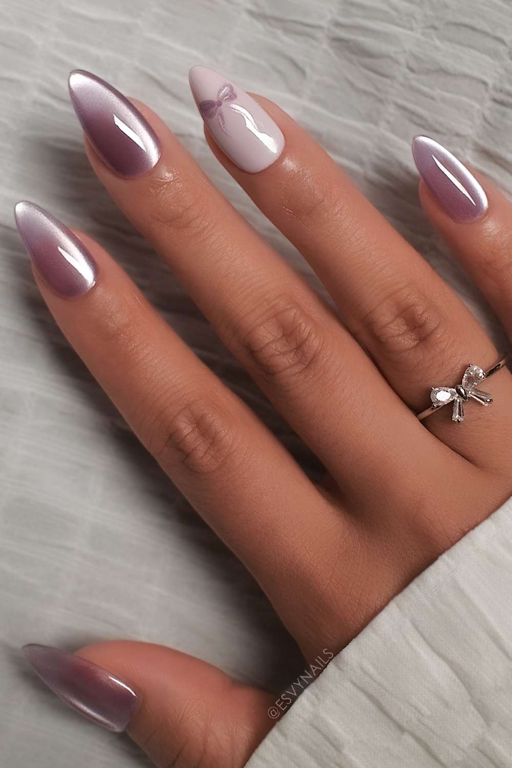 Purple cat eye nails with accent bows