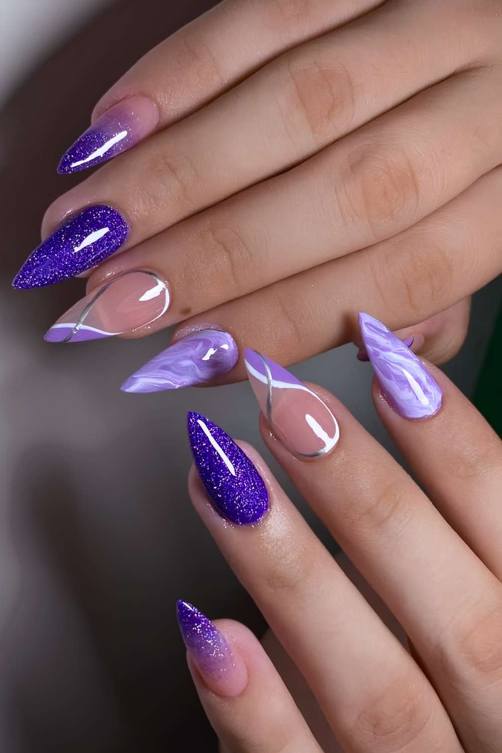 Purple marble nails with glitter accents