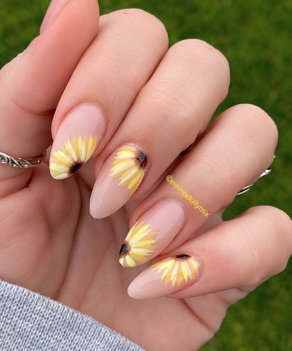 Sheer pink manicure with oversized sunflowers