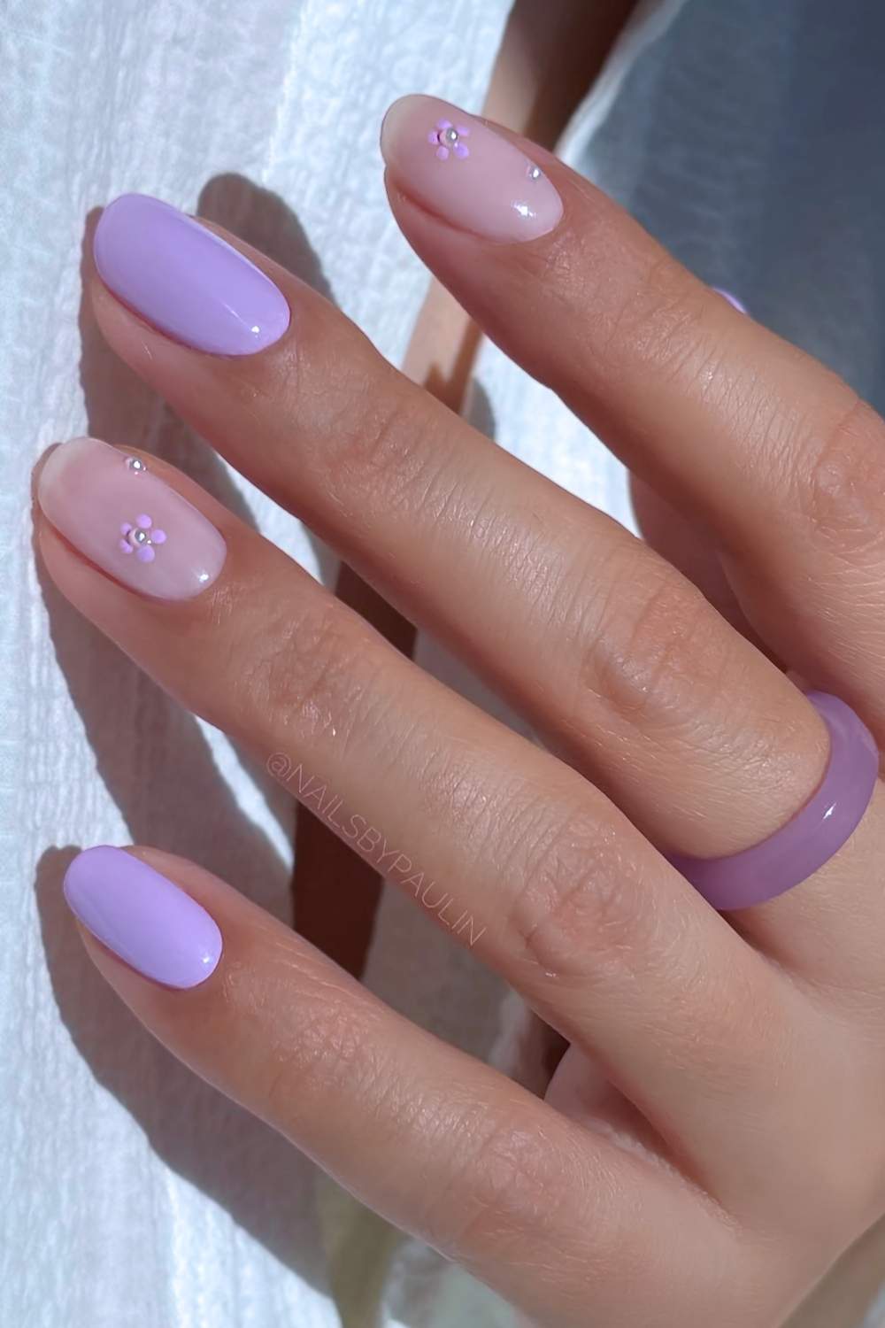 Short purple nails with flowers and pearls
