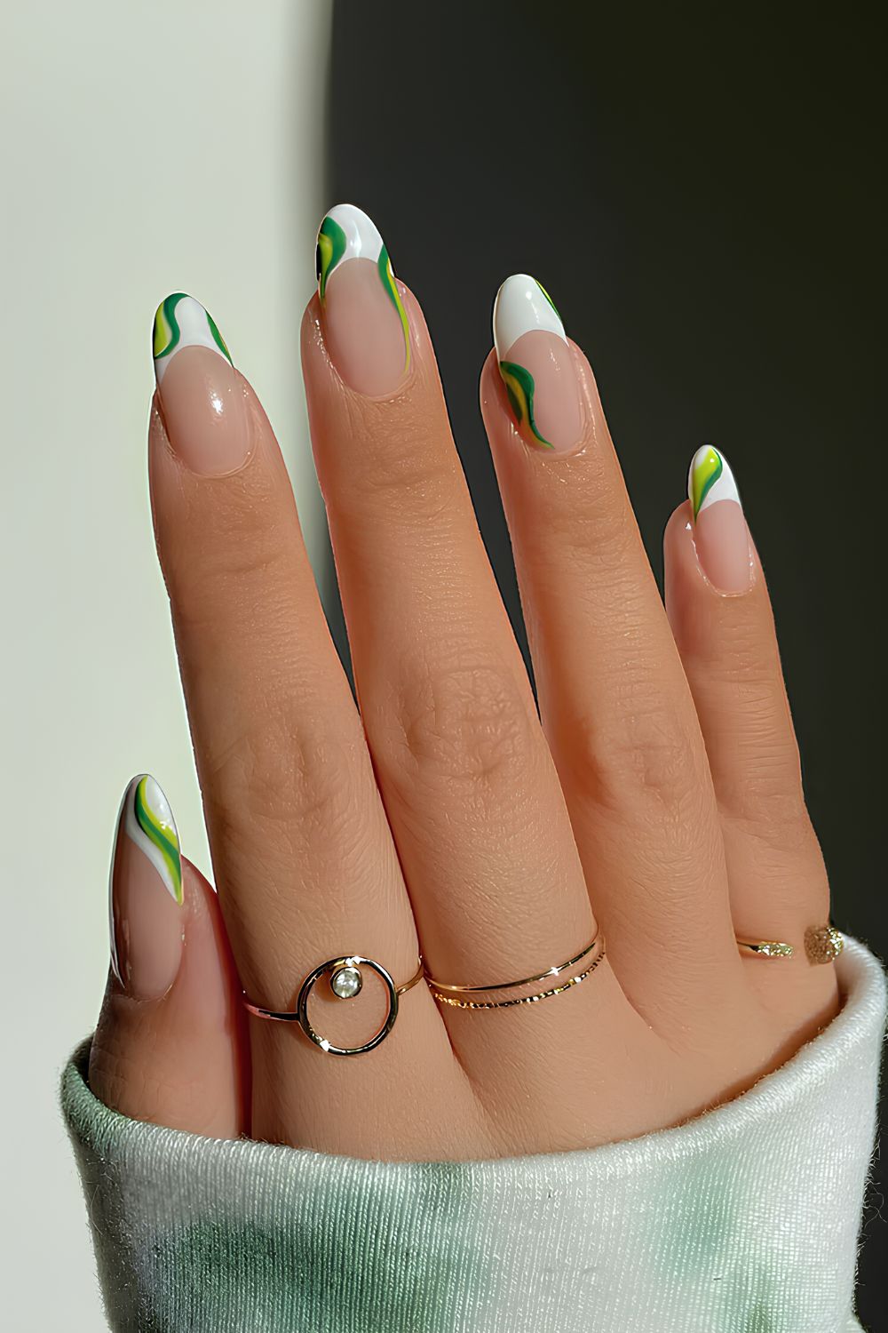 White French nails with green swirls